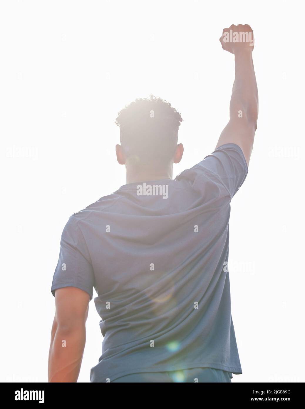 Uno per tutti. Dietro l'inquadratura di un giovane atleta maschile irriconoscibile in piedi all'esterno con la mano in aria. Foto Stock