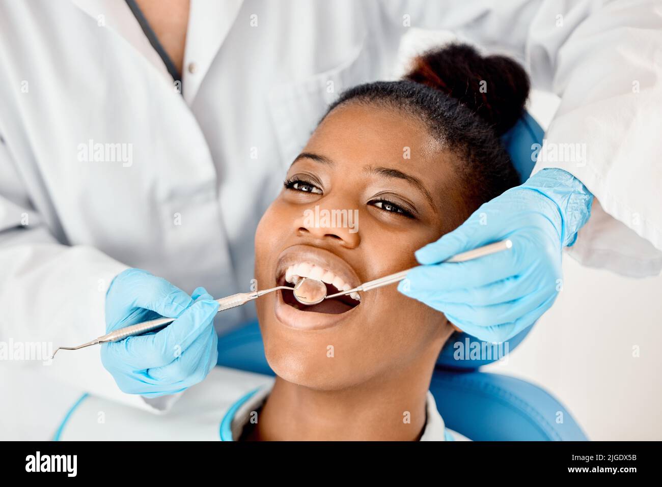 Gengive sane significano una bocca sana. Una giovane paziente femmina che ha i denti esaminati. Foto Stock