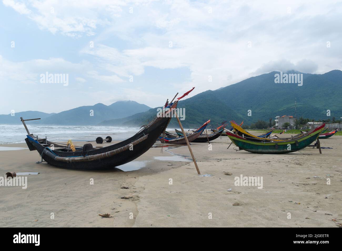 Barche da pesca curvate sulla spiaggia sabbiosa Lang Co, Vietnam. Piccole barche da pesca vietnamite sulla costa del Mar Cinese Meridionale Foto Stock