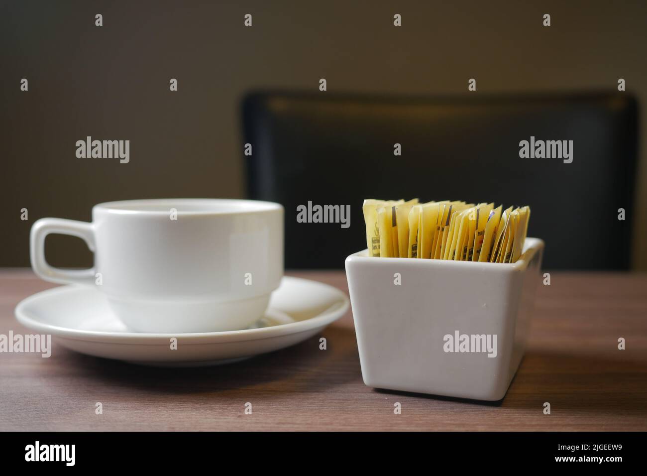 Pacchetto dolcificante sostitutivo dello zucchero e tazzina da tè su sfondo bianco Foto Stock