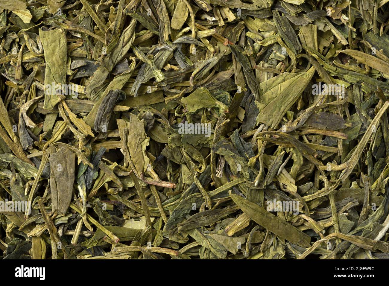 Dried Chinese Lung Ching foglie di tè primo piano full frame come sfondo Foto Stock
