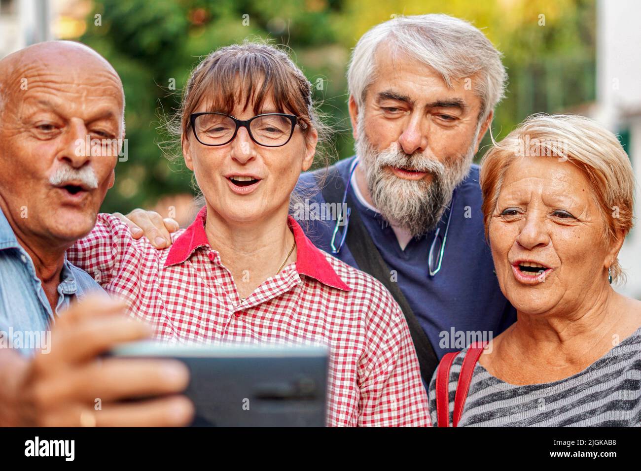 Coppie anziane che prendono selfie con smartphone - riunione degli amici anziani divertirsi all'aperto con gli altri Foto Stock