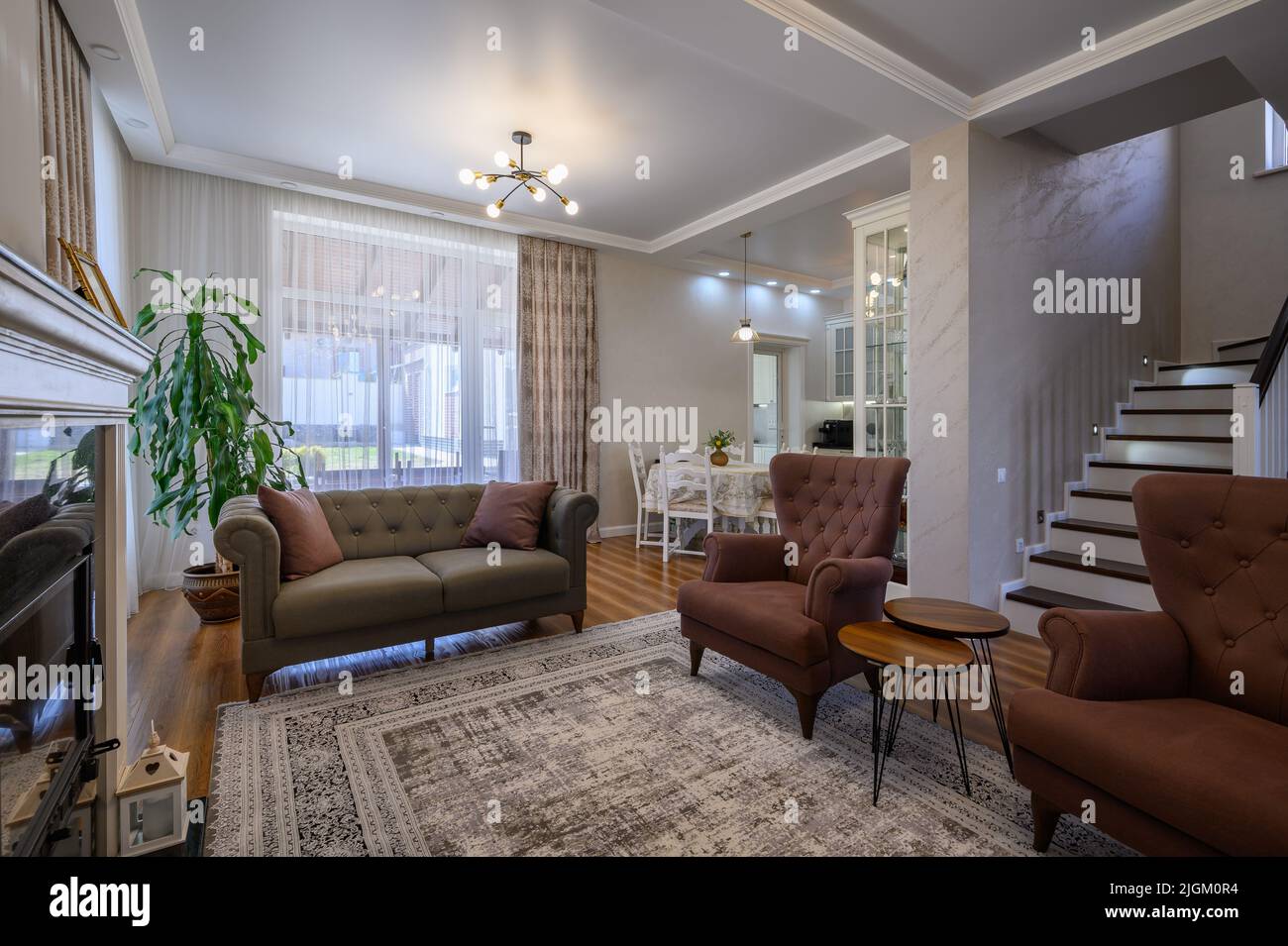 Appartamento monolocale con soggiorno con grande cucina bianca e tavolo da pranzo Foto Stock