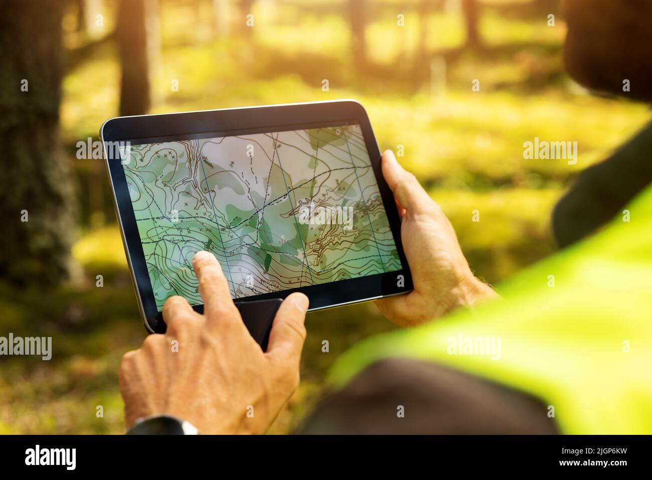 surveyor che lavora con mappa topografica forestale in tablet digitale. topografia terrestre Foto Stock