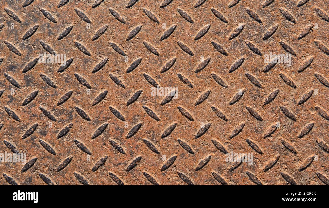 Un motivo metallico corroso. Una piastra in metallo arrugginito senza cuciture. Sfondo metallico astratto. Un interessante vecchio modello in acciaio per i vostri progetti. Foto Stock