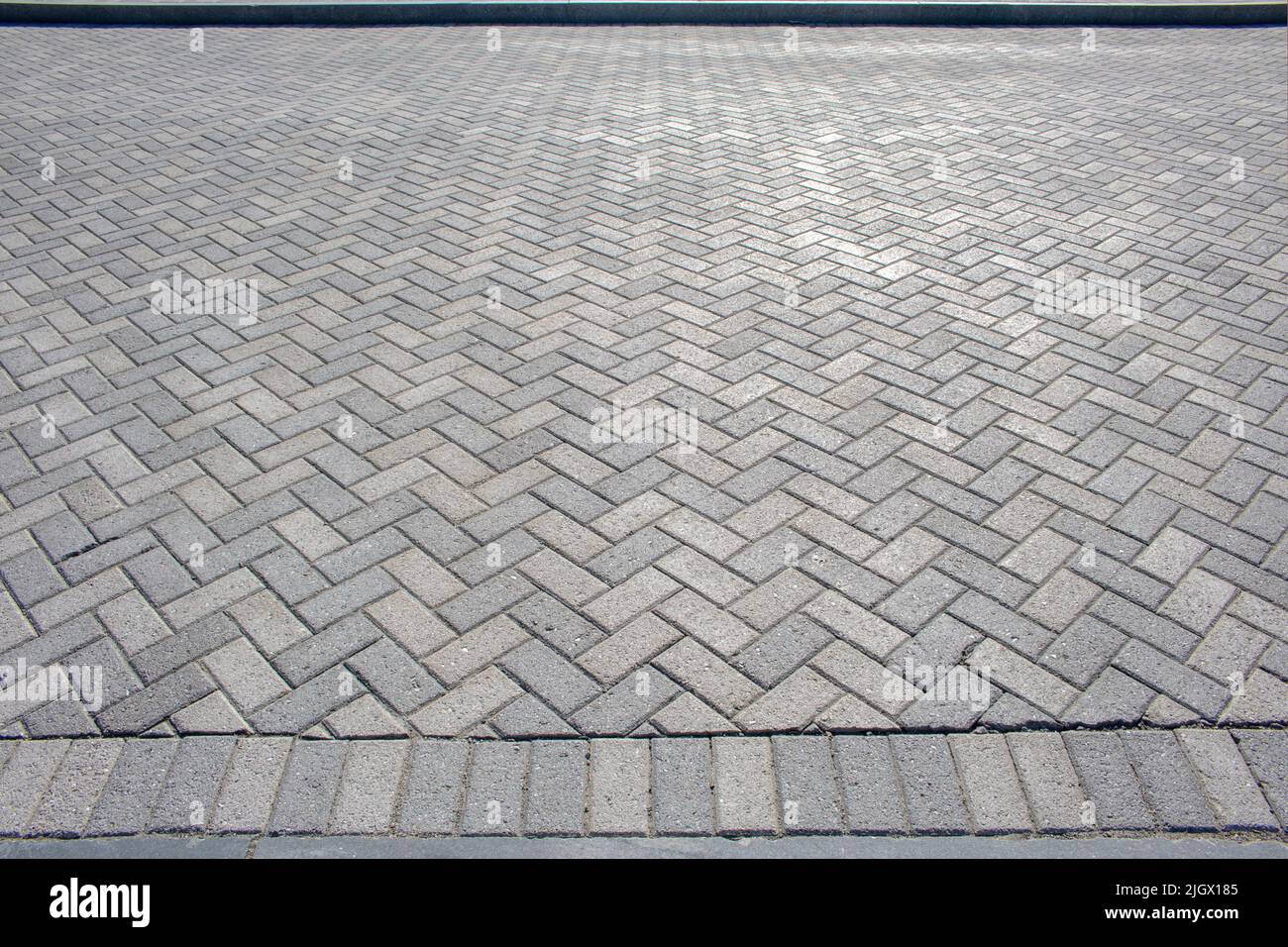 Textured chevron sfondo motivo herringbone mattone pavimento passerella o patio Foto Stock