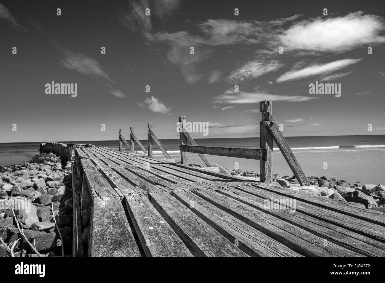Vecchio frangiflutti alla spiaggia di Lossiemouth in Black and White, Moray Coast Scotland Foto Stock