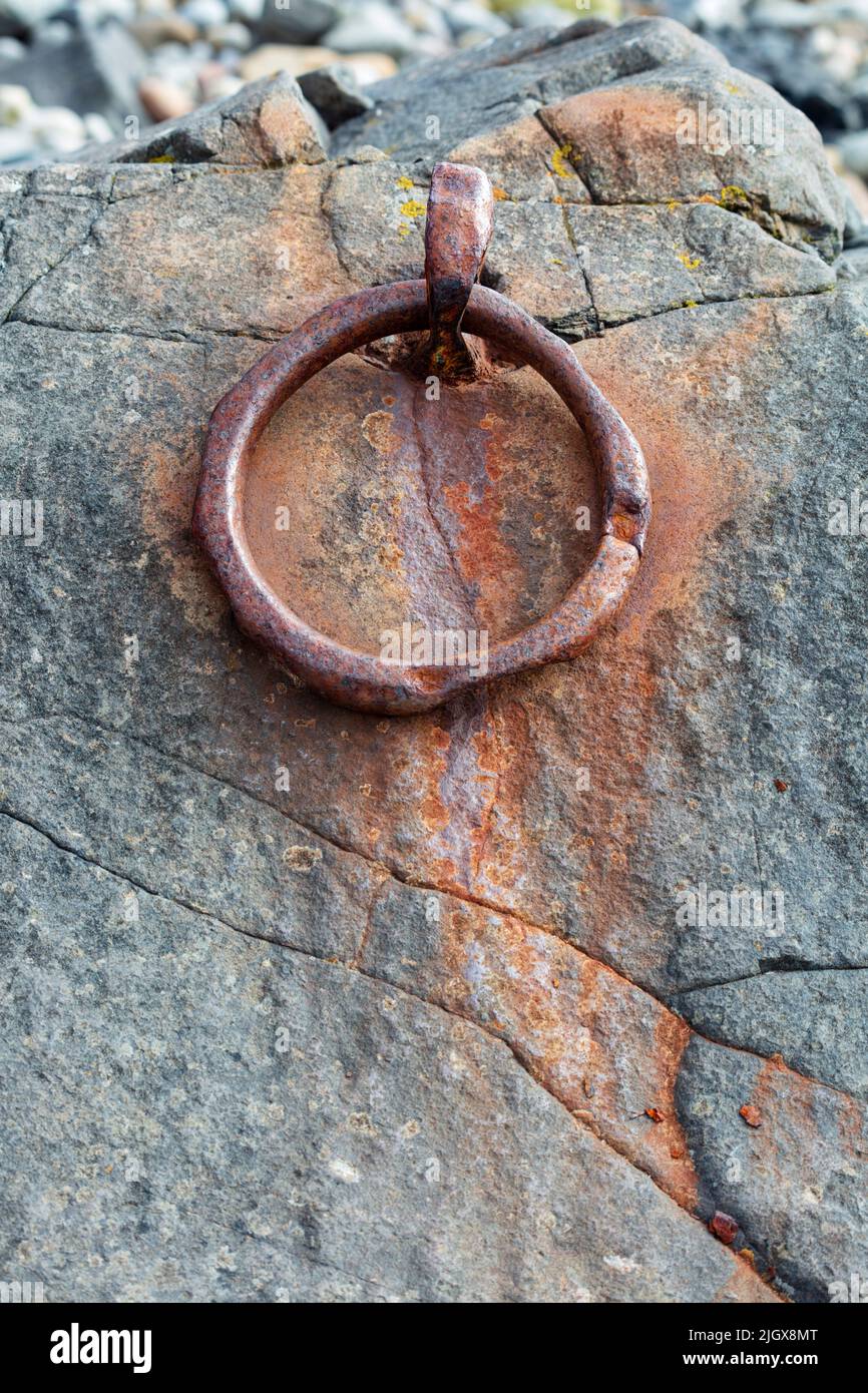 Anello di metallo arrugginito su roccia sulla spiaggia, Holy Island, Northumberland, Inghilterra, Regno Unito, Europa Foto Stock
