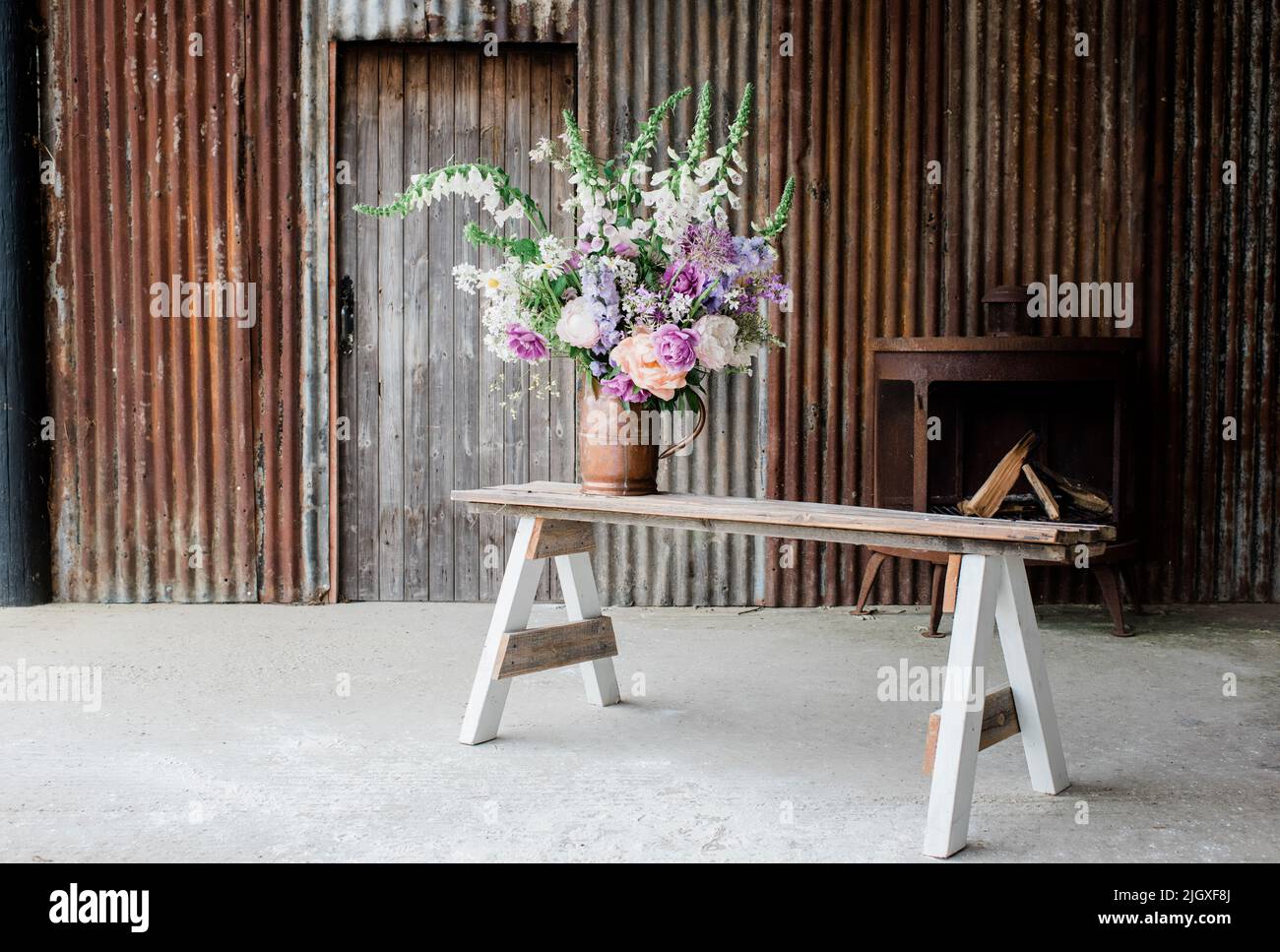 bei fiori su una panca in un fienile pronto a fotografare per un tiro Foto Stock
