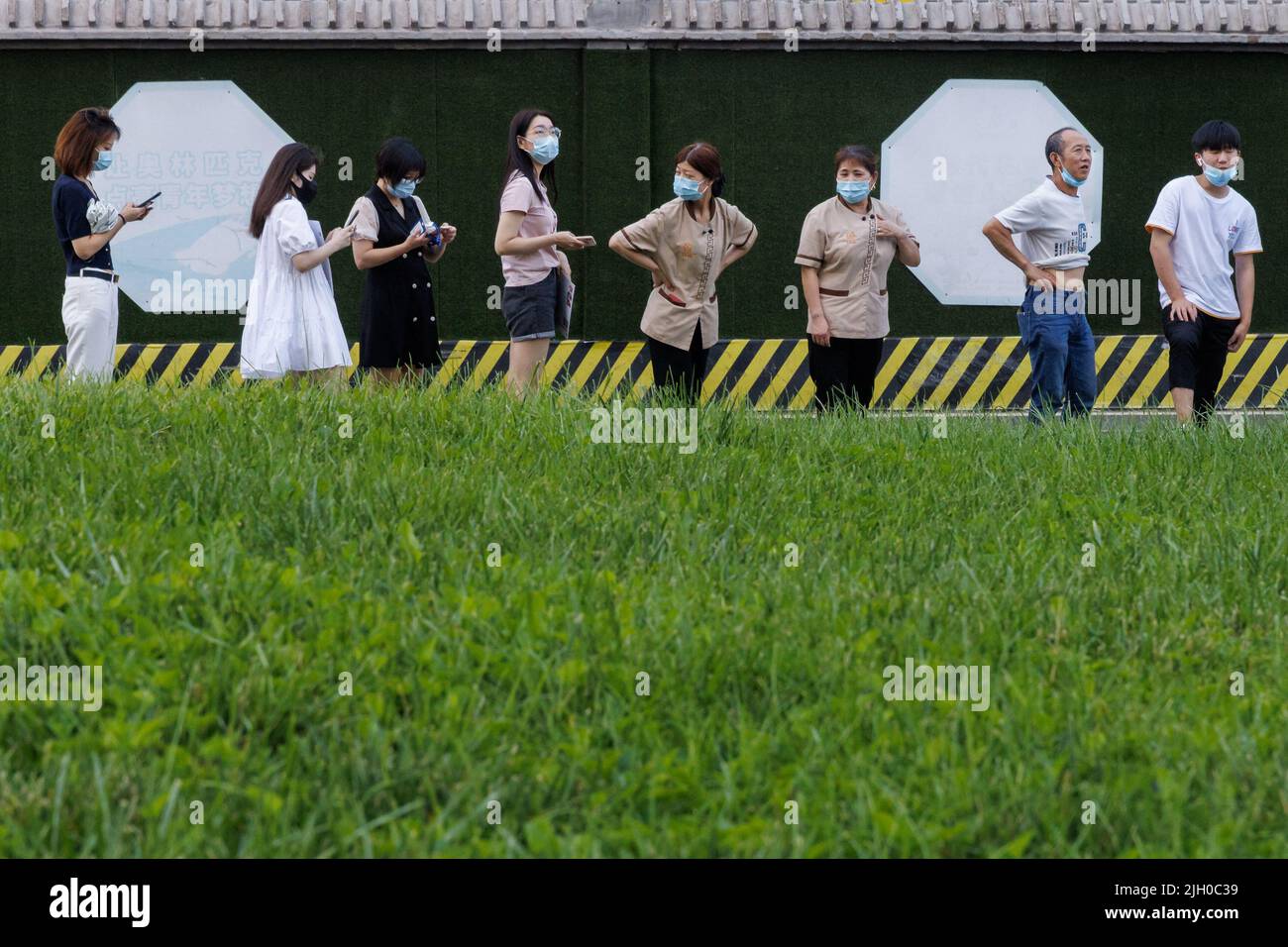 Le persone si allineano in una stazione di analisi degli acidi nucleici, a seguito di un focolaio di coronavirus (COVID-19), a Pechino, Cina, 14 luglio 2022. REUTERS/Thomas Peter Foto Stock