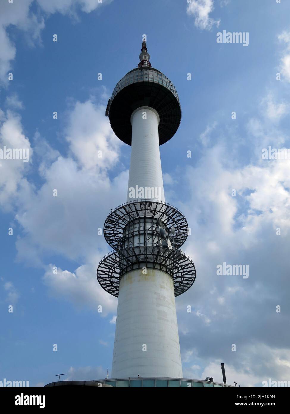 Una vista ad angolo basso della Torre Namsan a Seul Corea del Sud con un cielo blu nuvoloso sullo sfondo Foto Stock