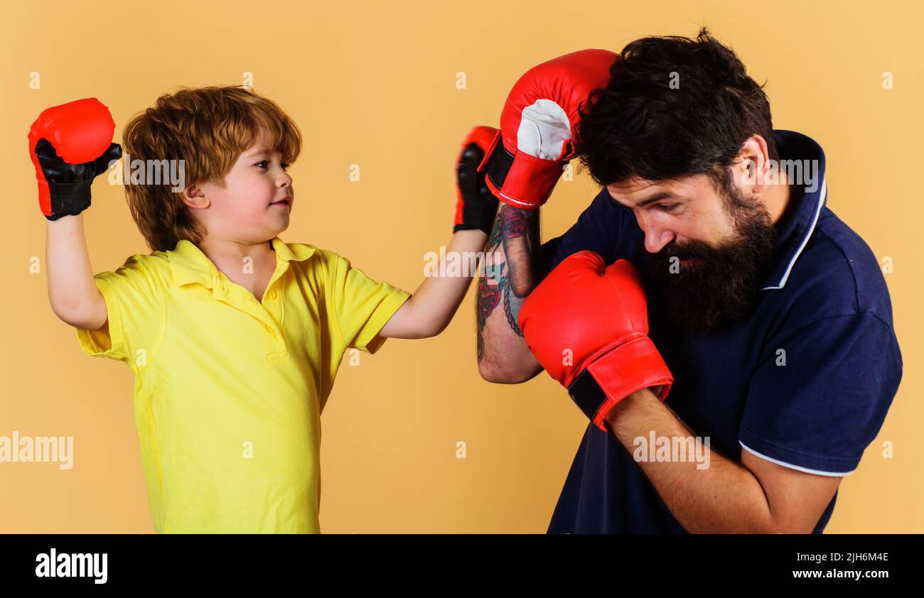 Addestratore che insegna al bambino come colpire i pugni. Addestramento del bambino di boxe. Attività infantile. Giorno di fitness. Foto Stock