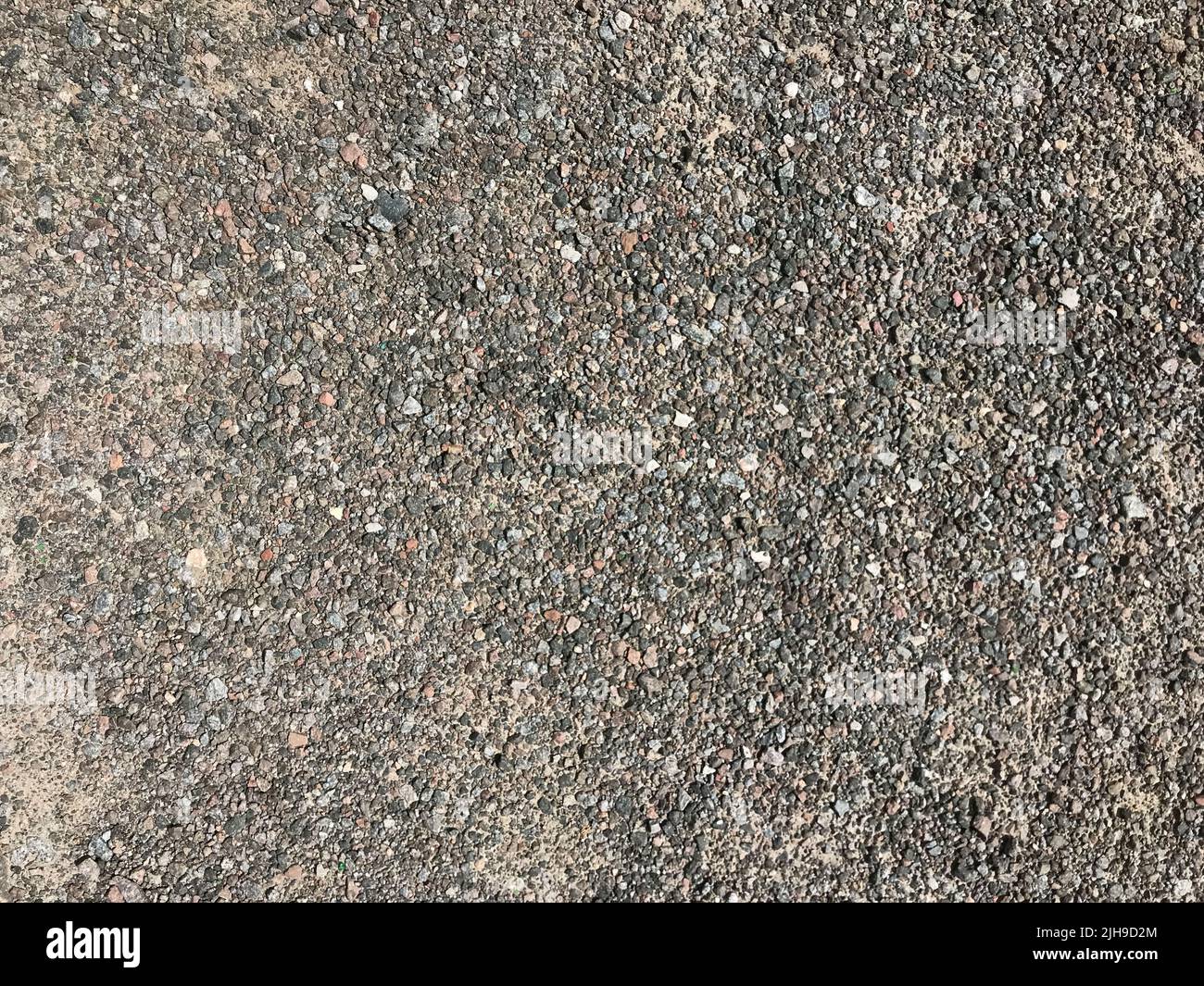 Texture di ciottoli, ghiaia, superficie stradale urbana, superficie del suolo. Foto Stock