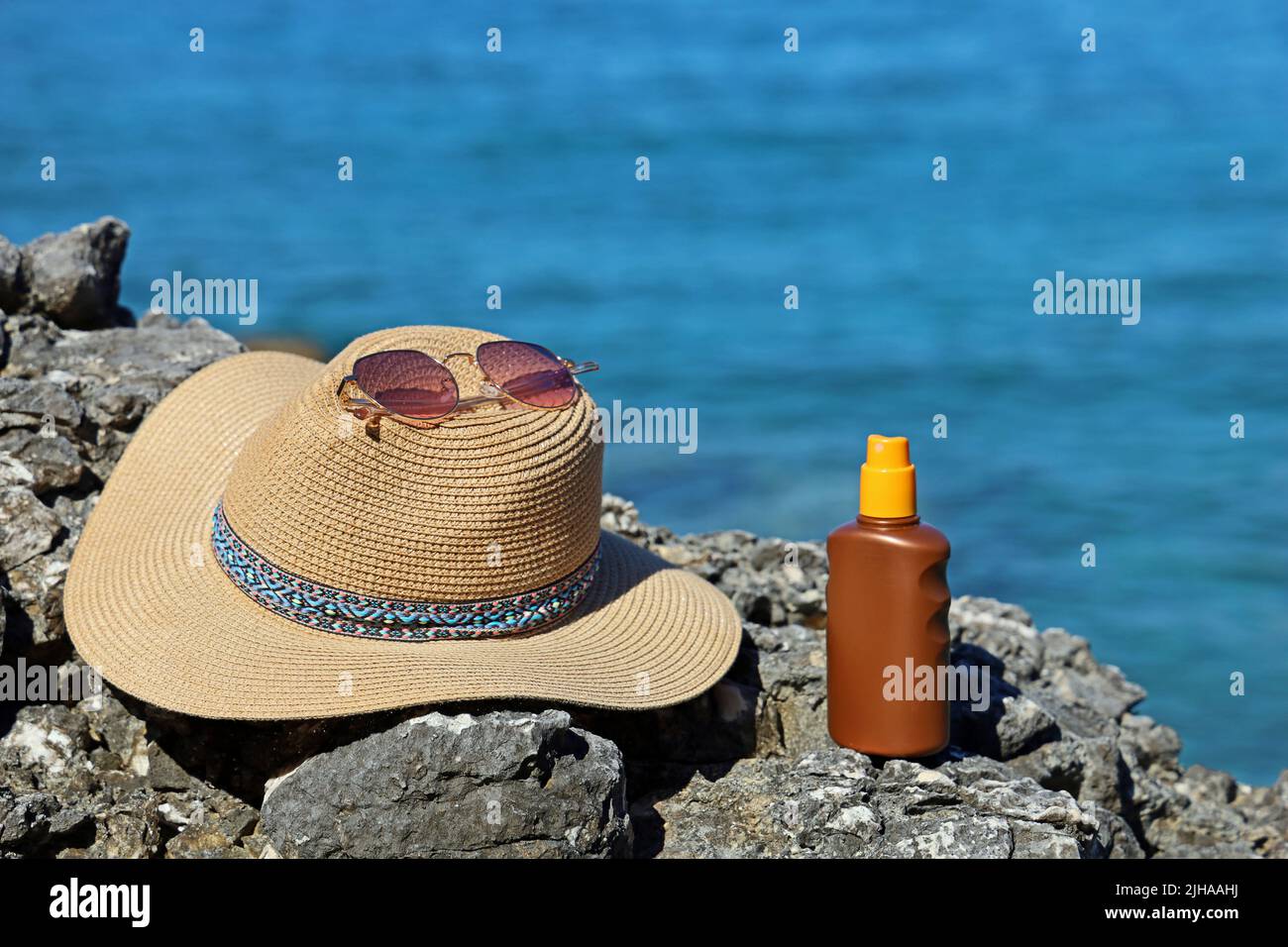 Occhiali da sole, cappello e crema solare al mare, protezione UV per vacanze senza scottature Foto Stock
