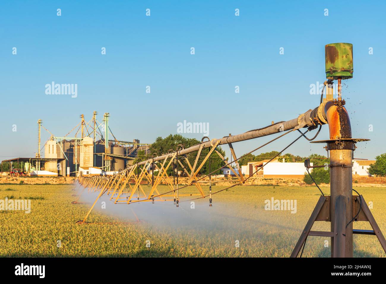 Sistema di irrigazione centrale a perno, tubi di irrigazione con sprinkler su ruote che ruotano su un asse centrale. Foto Stock