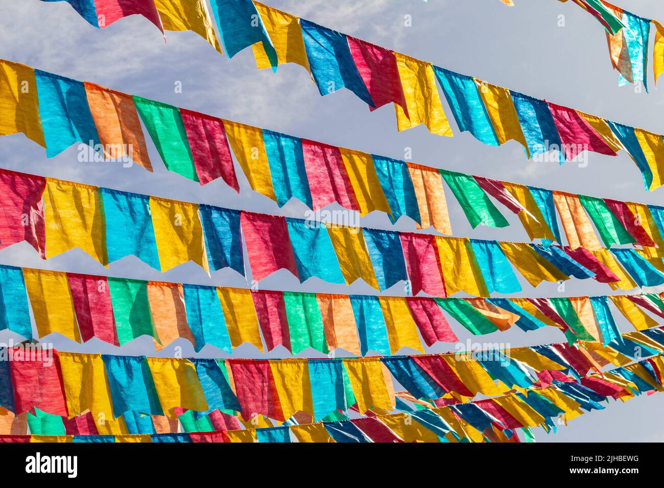 Goiania, Goiás, Brasile – 17 luglio 2022: Diverse linee di abbigliamento con bandiere di tessuto contro il cielo blu per la festa di giugno - tipico brasiliano 'Quadrilha' Foto Stock