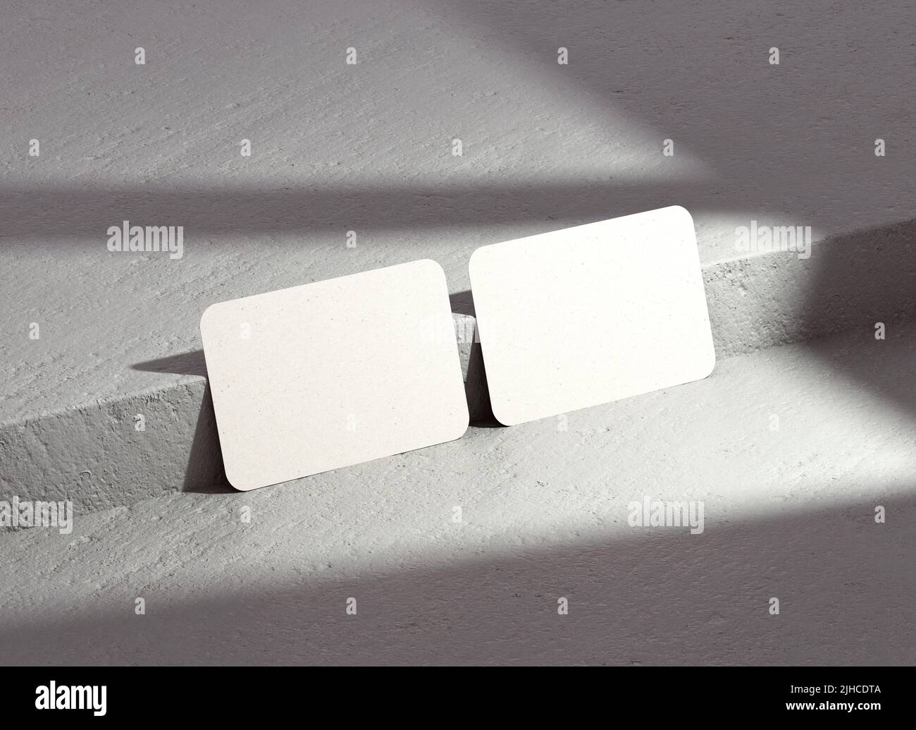 Due angoli arrotondati biglietto da visita mockup con ombre per marcare a caldo presentazione, identità aziendale, modello di cancelleria su uno sfondo concreto. Mod Foto Stock