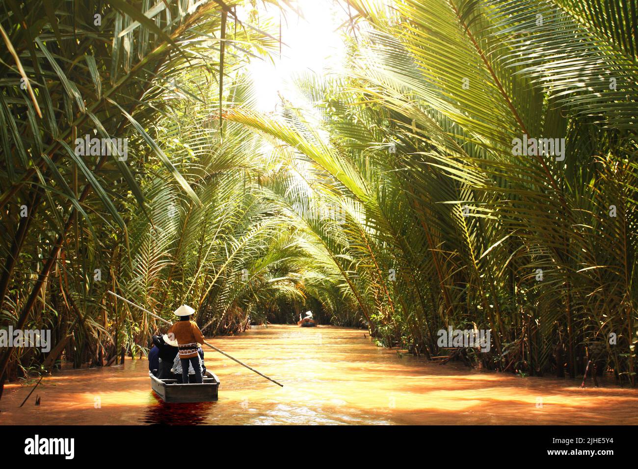 Persone in barca nel delta del fiume Mekong, Vietnam, Asia. Un'attrazione turistica - giro in barca attraverso i canali del delta del Mekong Foto Stock