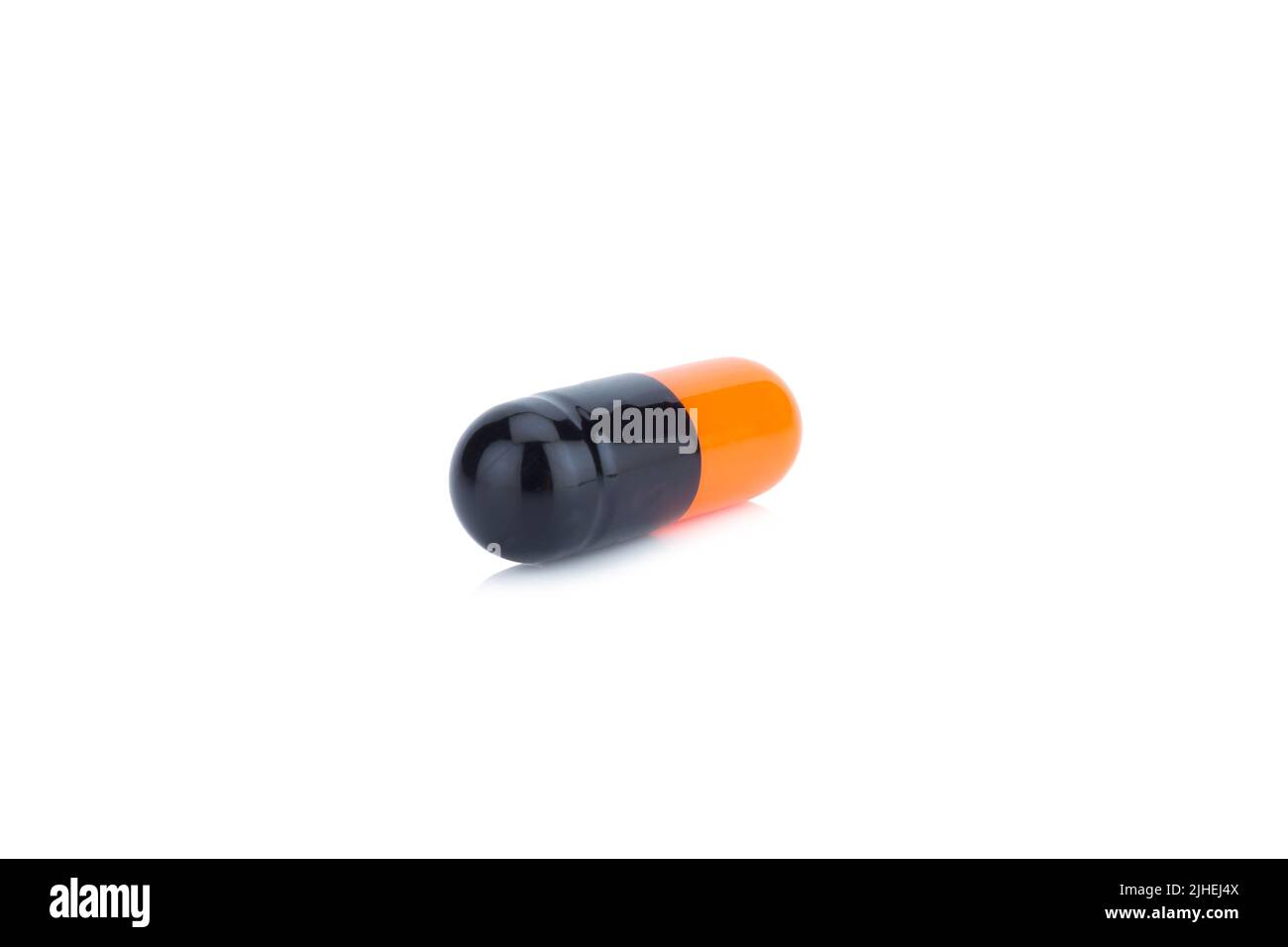 Colore della capsula Nero e arancione isolato su sfondo bianco Foto Stock