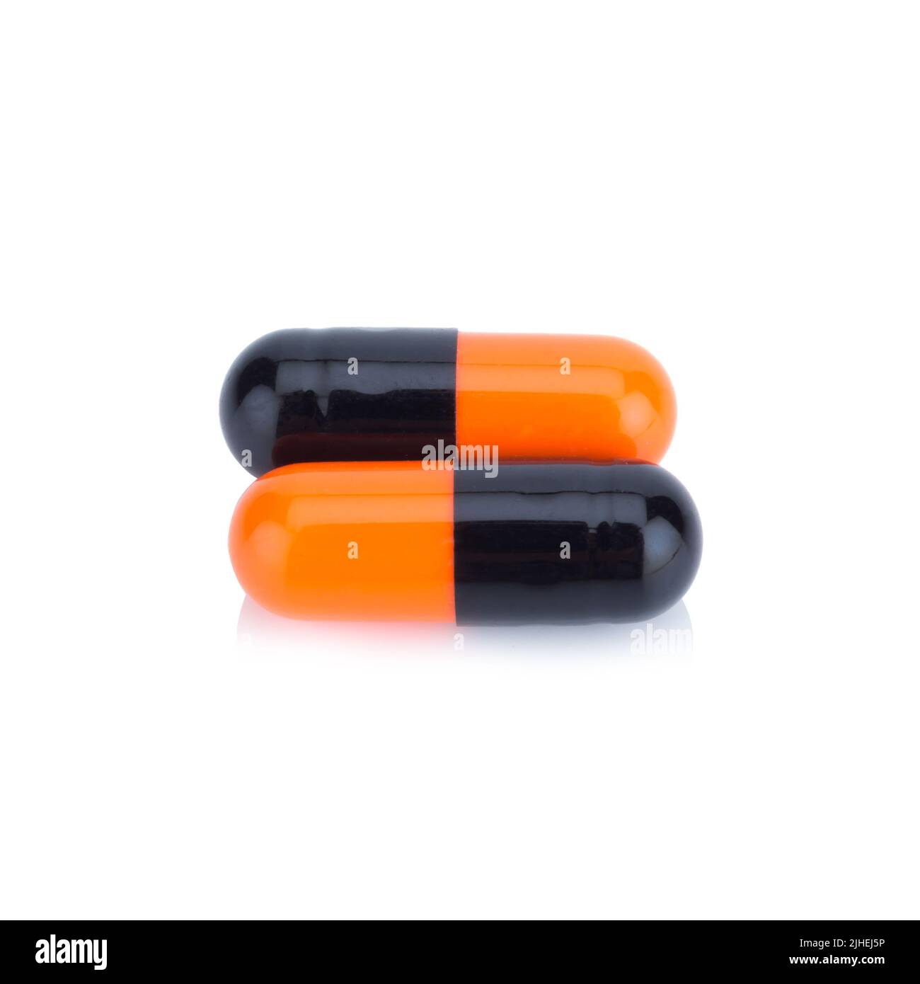 Due capsule di colore Nero e arancione isolate su sfondo bianco Foto Stock