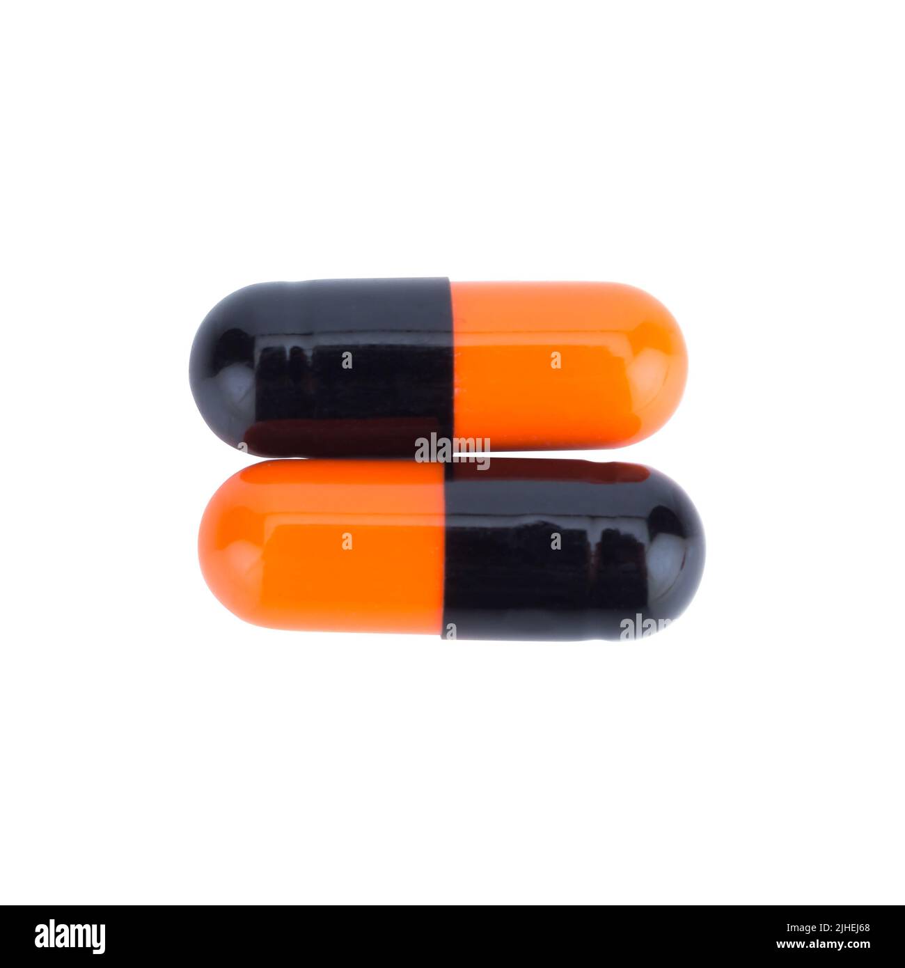 Due capsule di colore Nero e arancione isolate su sfondo bianco Foto Stock