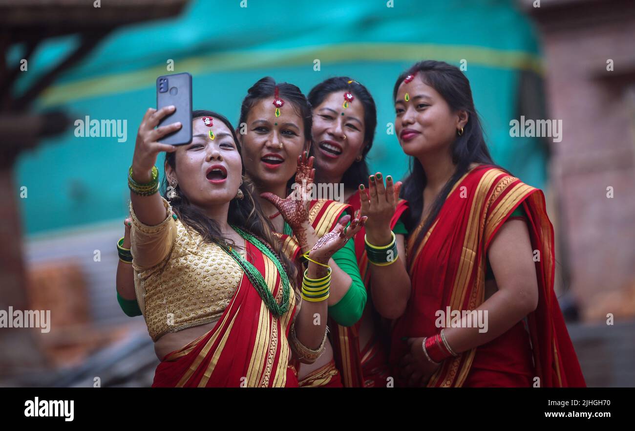 Kathmandu, Bagmati, Nepal. 18th luglio 2022. Le donne nepalesi si gesti prendendo un selfie di gruppo dopo aver offerto preghiere su Shrawan Somvar vicino ad un tempio Shiva a Kathmandu. Lunedì o Somvars del mese santo Shrawan sono considerati auspious mentre la gente digiuna ed offre le preghiere al Signore Shiva e primariamente le donne digiunano e pregano per una vita prospera e lunga dei loro mariti o desiderano trovarne una buona. (Credit Image: © Sunil Sharma/ZUMA Press Wire) Foto Stock