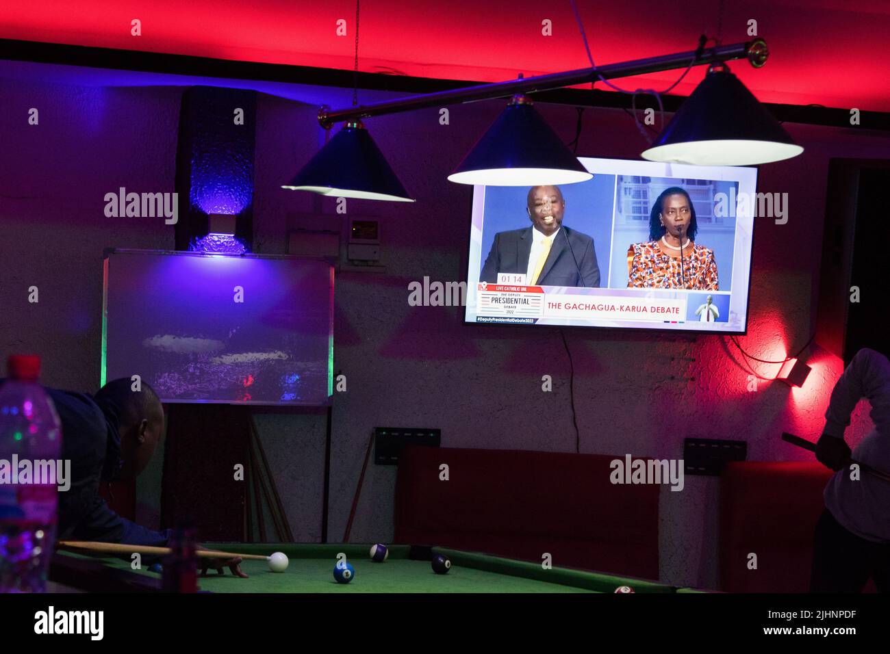 Nakuru, Kenya. 19th luglio 2022. Gli uomini suonano snooker di fronte a uno schermo TV che trasmette in diretta la trasmissione del dibattito presidenziale del deputato con Azimio la Umoja politico Coalitionís Martha Karua e Kenia Kwanza politico Coalitionís Rigathi Gachagua. Il dibattito è stato trasmesso attraverso le principali stazioni di radiodiffusione e piattaforme digitali in Kenya. I debitori hanno avuto l’opportunità di dire ai keniani le loro priorità chiave nel caso in cui dovessero formare il prossimo governo. Il Kenya terrà le sue elezioni generali il 9 agosto 2022. (Foto di James Wakibia/SOPA Images/Sipa USA) Credit: Sipa USA/Alamy Live News Foto Stock