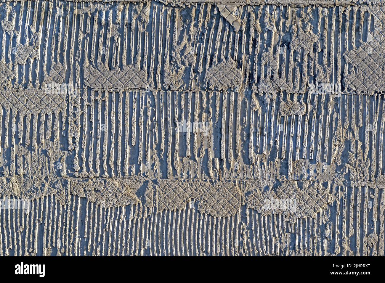 astratto irregolare goffrato parete di calcestruzzo, pietra materiale texture closeup diversità Foto Stock