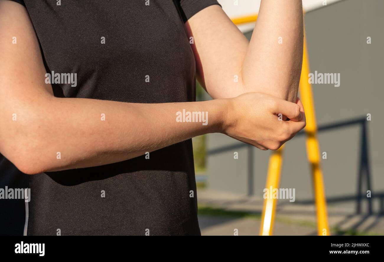 Sportswoman che soffre di dolore al gomito. Infiammazione e gonfiore dei tendini del braccio. Problemi di salute causati dal concetto di sport. Foto di alta qualità Foto Stock