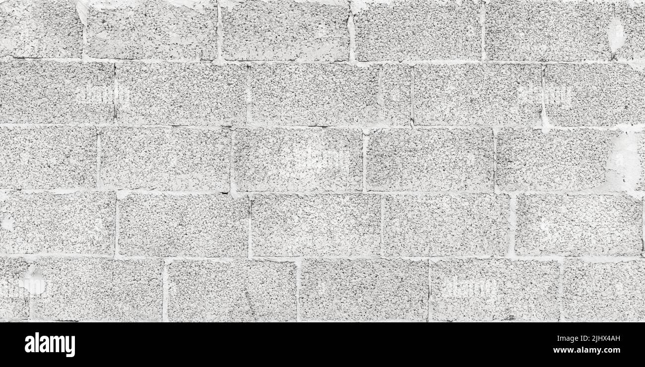 Struttura della parete in mattoni grigi, fondo in calcestruzzo grigio chiaro, superficie della parete in cemento. Spazio vuoto. Carta da parati grunge naturale, sfondo grezzo intemperato, ampia ba Foto Stock