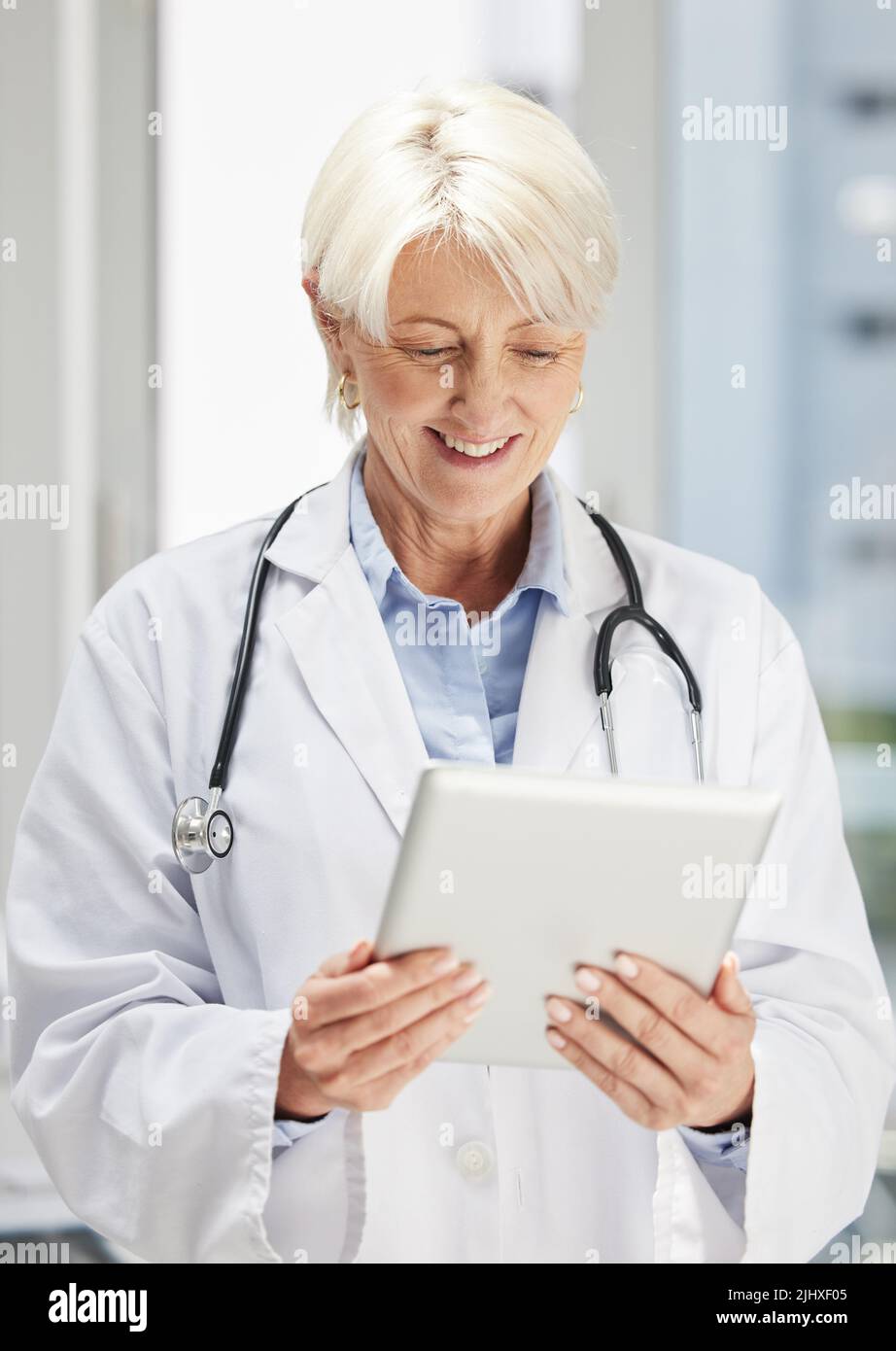 sfruttare al massimo il mondo tecnologico. un medico esperto e sicuro che utilizza un tablet digitale. Foto Stock