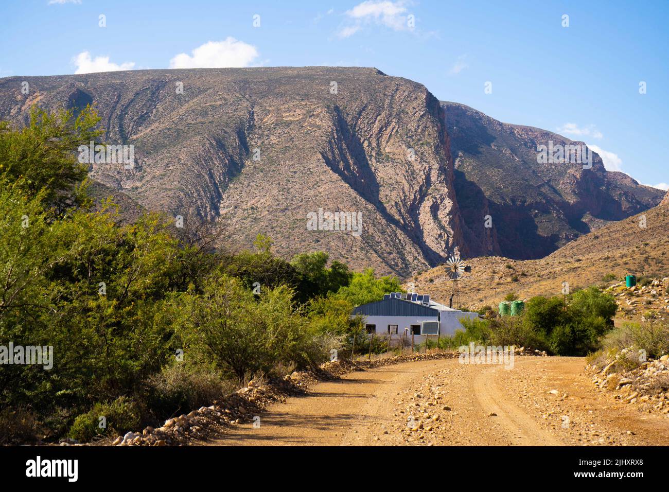 Fattoria circondata da grandi montagne Foto Stock