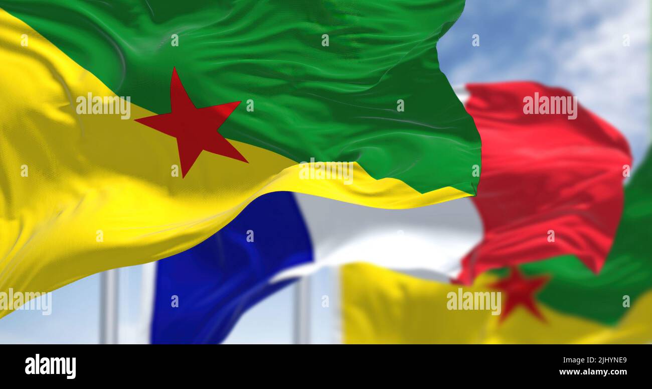 Bandiere nazionali della Guiana francese che sventolano con la bandiera della Francia in una giornata chiara. La Guyana Francese è un dipartimento/regione d'oltremare e un unico territorio c Foto Stock