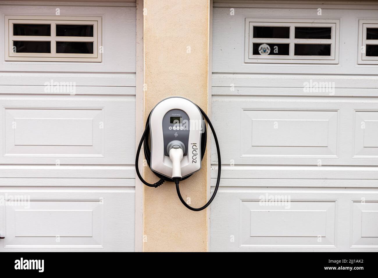 Vista esterna di un wallpod adattivo Zappi Smart EV montato a parete, di un veicolo elettrico o di un punto di ricarica ibrido plug-in per un edificio residenziale Foto Stock