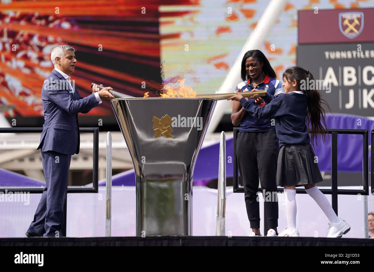 Il sindaco di Londra Sadiq Khan (a sinistra) e i medalisti d'oro olimpici Christine Ohuruogu (al centro) aiutano a illuminare la fiamma Legacy durante l'evento di 10th anni delle Olimpiadi di Londra del 2012 che si tiene al Bridge uno al Queen Elizabeth Olympic Park di Londra. Mercoledì 27 luglio segnerà esattamente 10 anni dalla cerimonia di apertura dei Giochi Olimpici di Londra 2012. Data foto: Venerdì 22 luglio 2022. Foto Stock