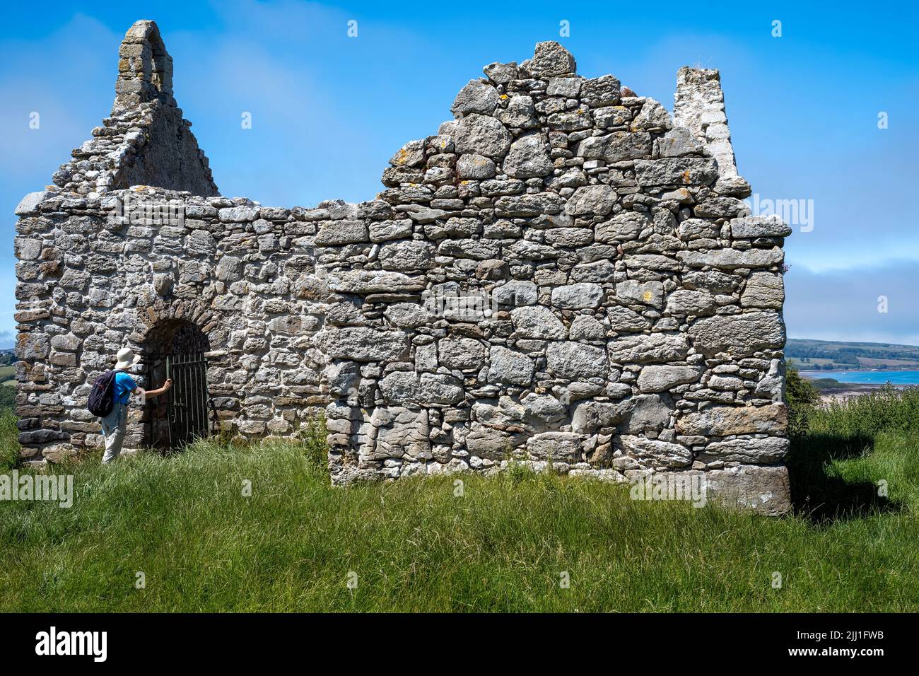 I resti austeri e remoti della vecchia cappella (medievale) a Lligwy, Moelfre, Anglesey, Galles, Regno Unito Foto Stock