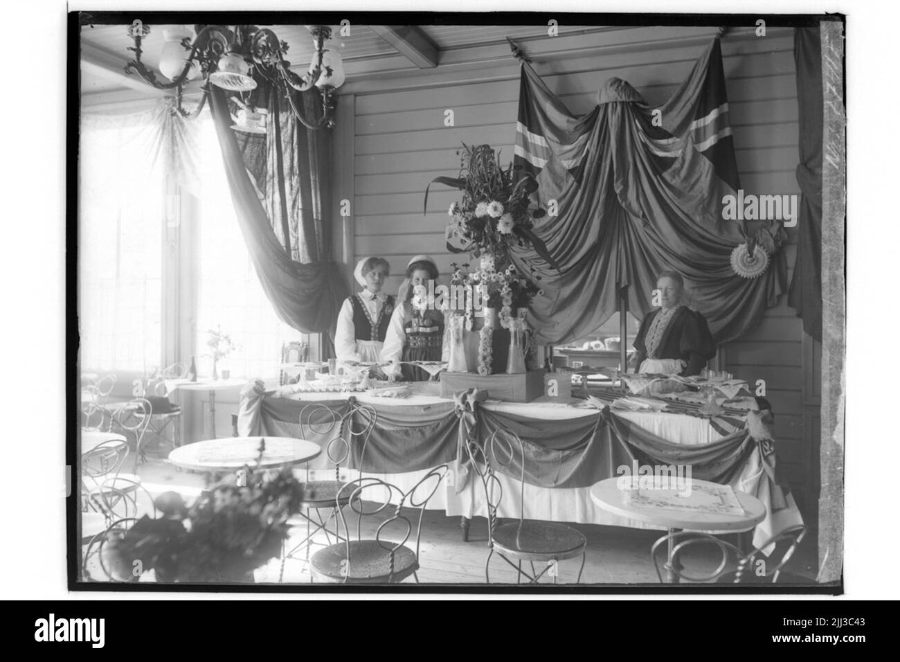 Basso di amici animali. Vendita di biscotti e omaggi. Tre donne in costumi nazionali. Foto Stock