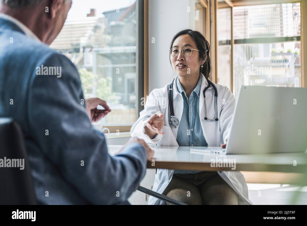 Medico che discute con il paziente in clinica medica Foto Stock