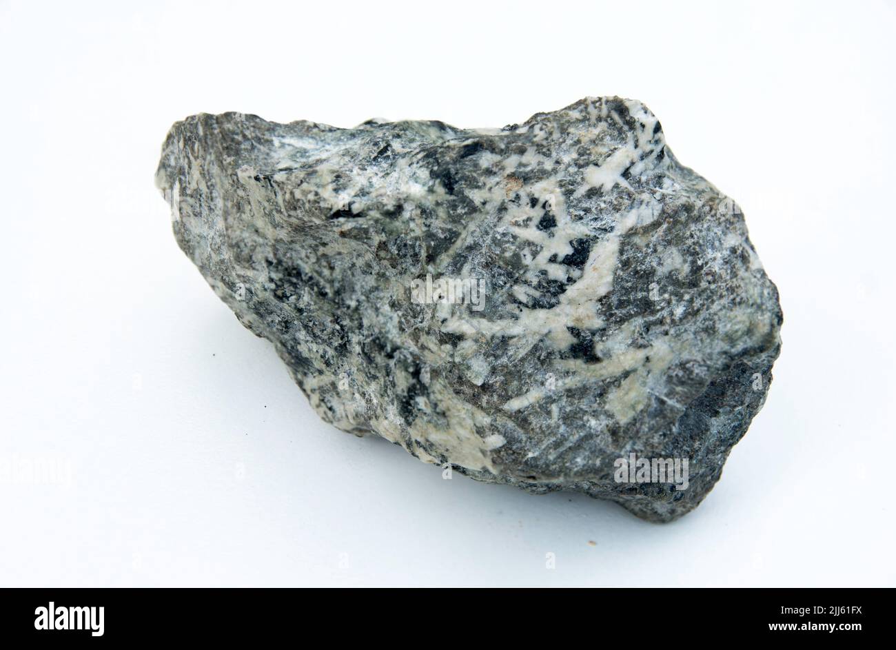 roccia ignea isolata su sfondo bianco Foto Stock