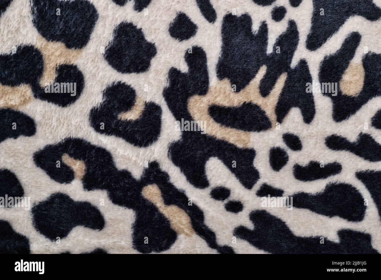 Motivo pelle leopardo su una coperta con colori bianco e nero, tema safari. Punto di vista campione con campitura di tessuto modellata direttamente dall'alto. Foto Stock