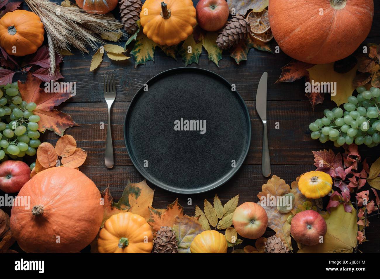 Posto tabella autunnale con foglie e zucche essiccate. Vista dall'alto. Buon giorno del Ringraziamento. Foto Stock