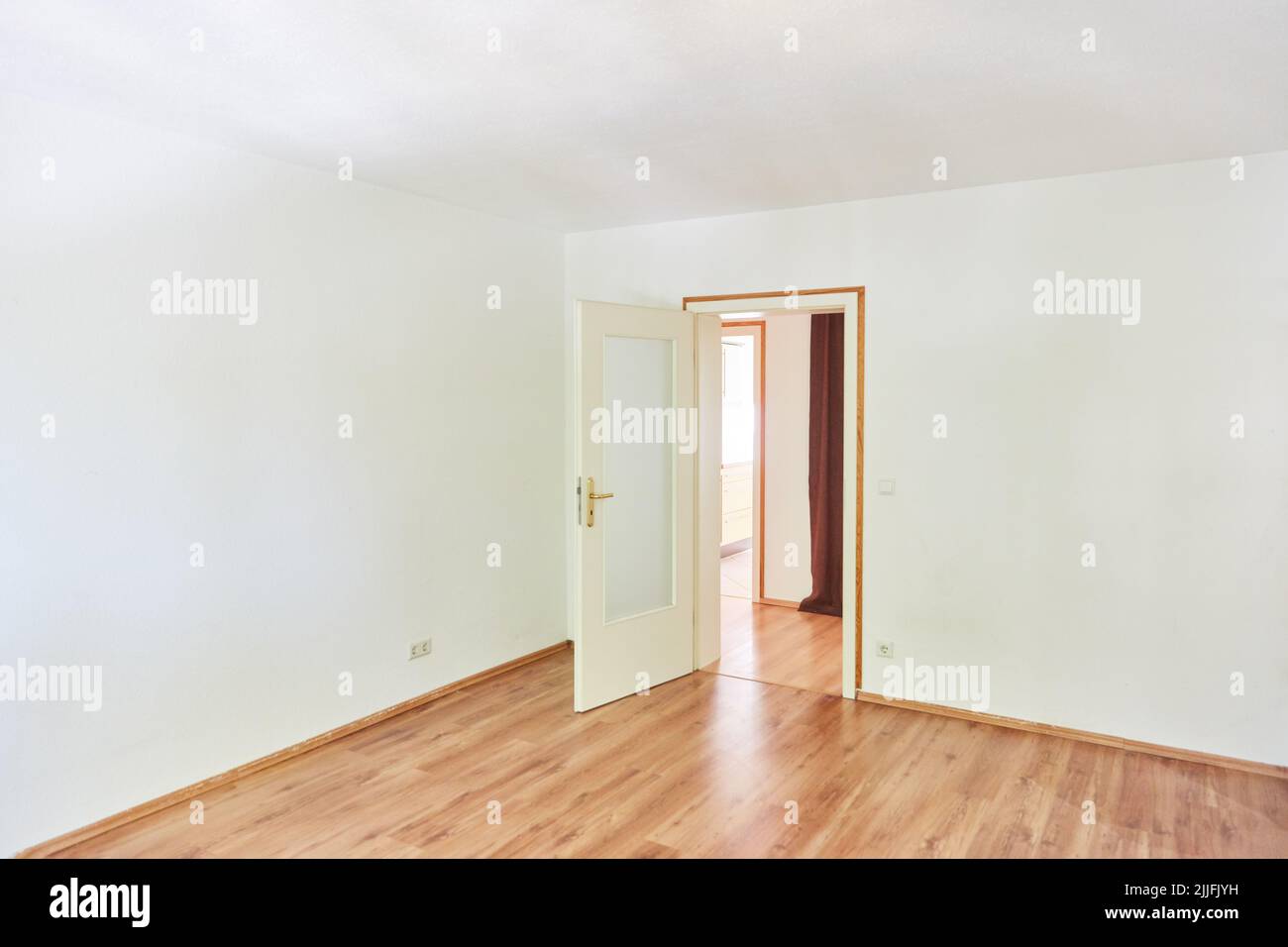 Camera vuota e luminosa con porta aperta in appartamento Foto Stock