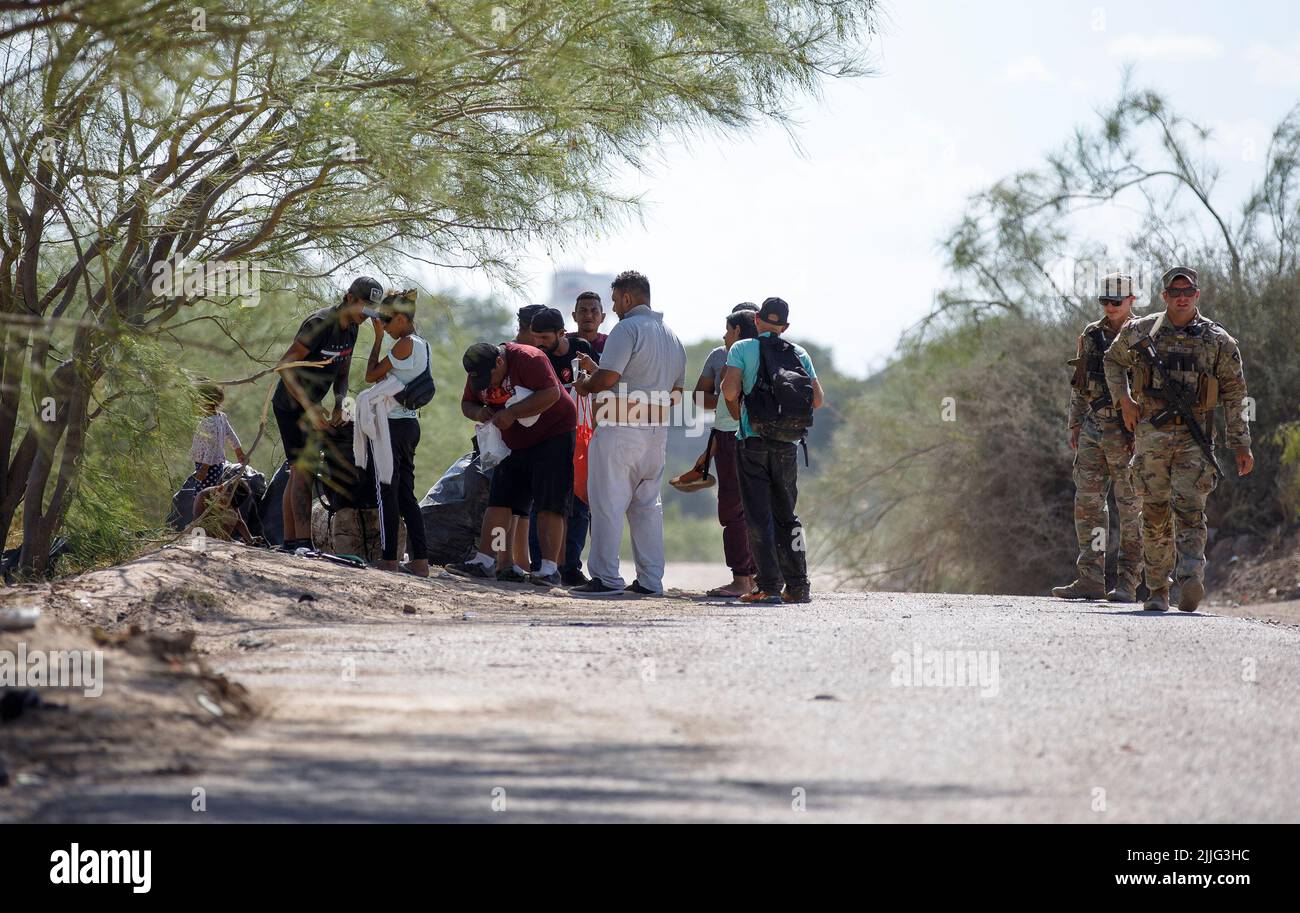 Houston, Texas, Stati Uniti. 24th luglio 2022. I soldati della Guardia Nazionale del Texas si trovano accanto ai migranti a Eagle Pass, Texas, negli Stati Uniti, il 24 luglio 2022. Credit: Nick Wagner/Xinhua/Alamy Live News Foto Stock