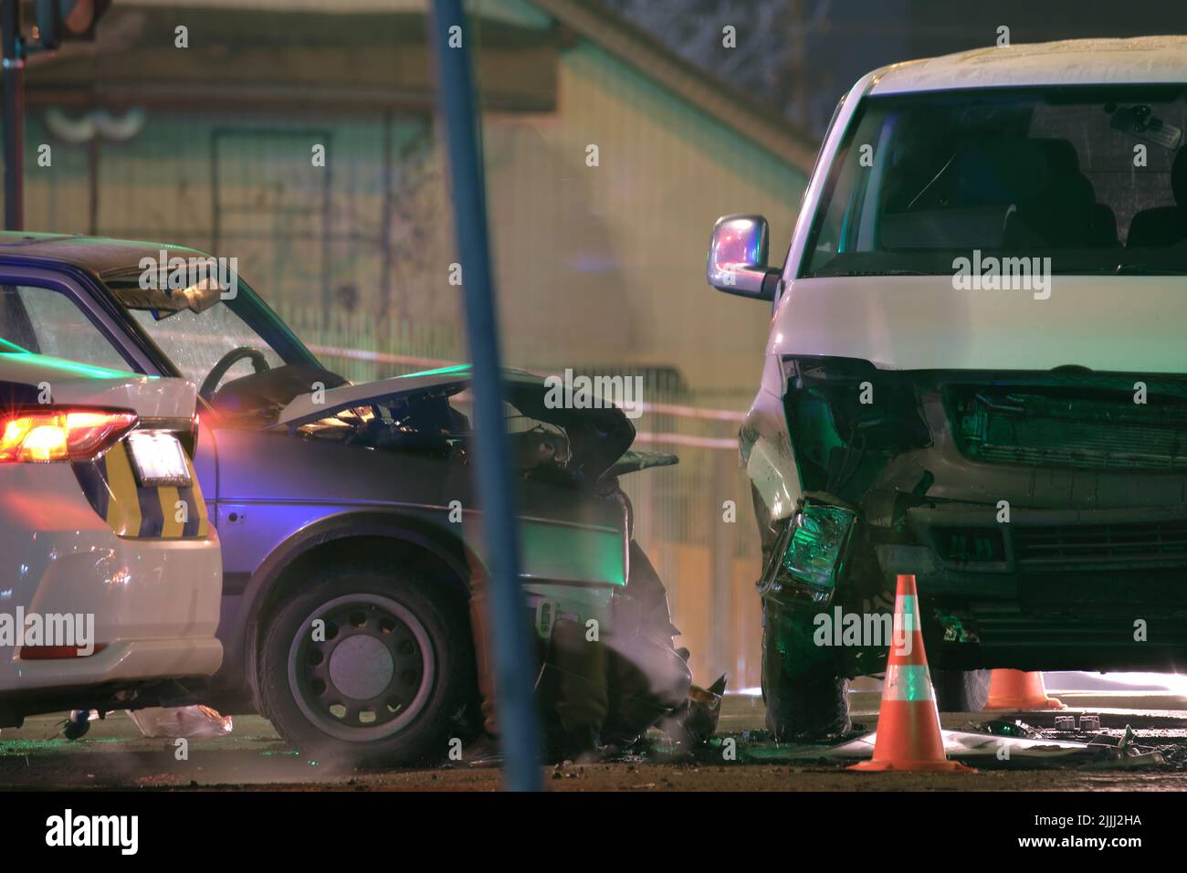 Le auto si sono schiantate pesantemente in caso di incidente stradale dopo la collisione sulla strada della città di notte. Sicurezza stradale e concetto di assicurazione Foto Stock