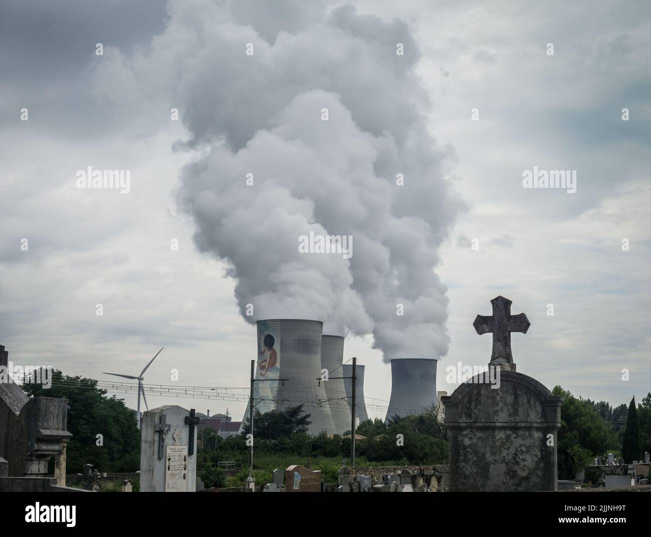Cruas, Francia. 01st ago 2015. Le torri di raffreddamento della centrale nucleare Cruas nel dipartimento di Ardeche nella regione Auvergne-Rhone-Alpes della Francia con un cimitero di fronte ad essa. Credit: Frank Rumpenhorst/dpa/Alamy Live News Foto Stock