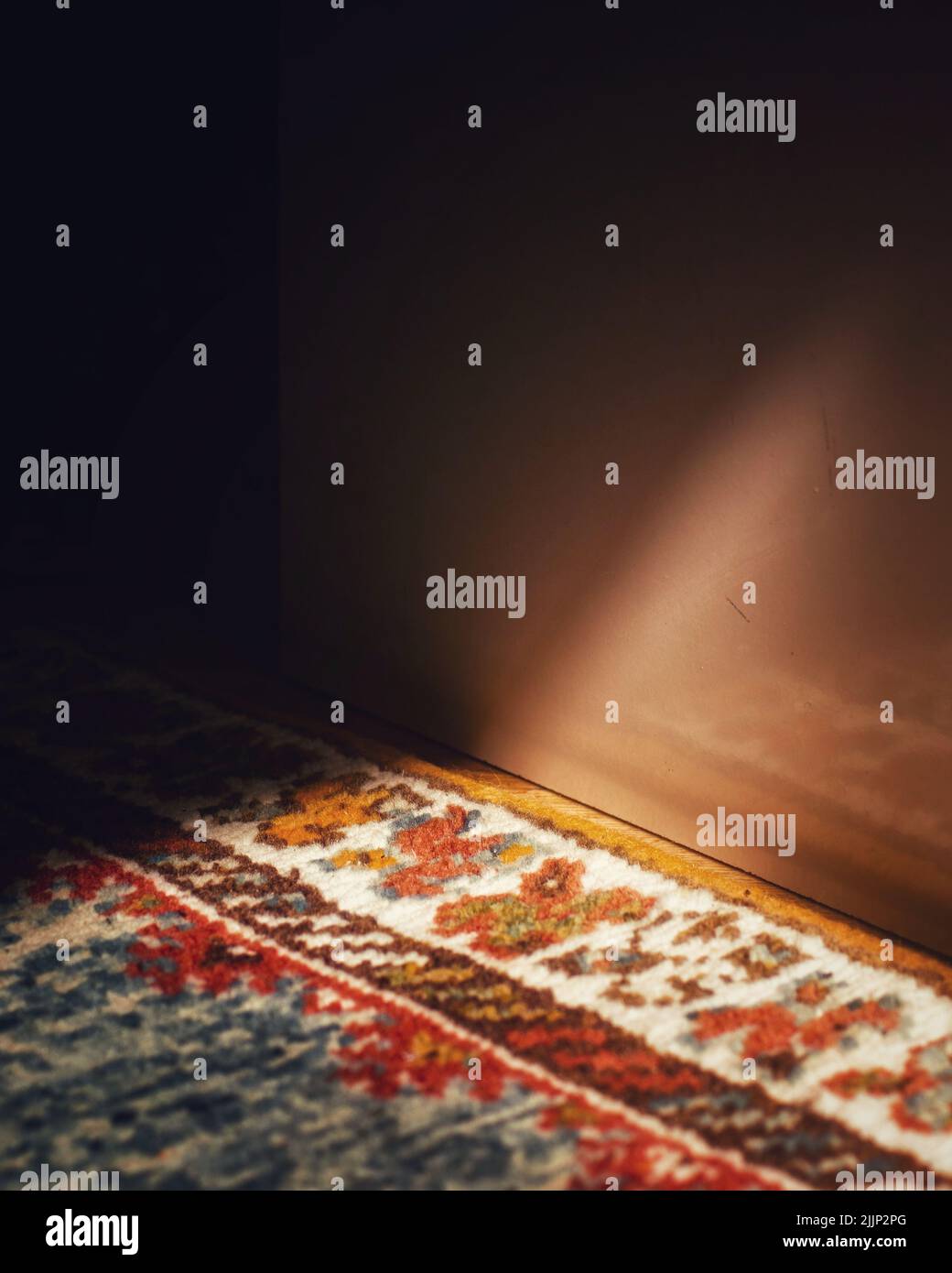 Il gioco della luce e dell'ombra sul tappeto colorato Foto Stock