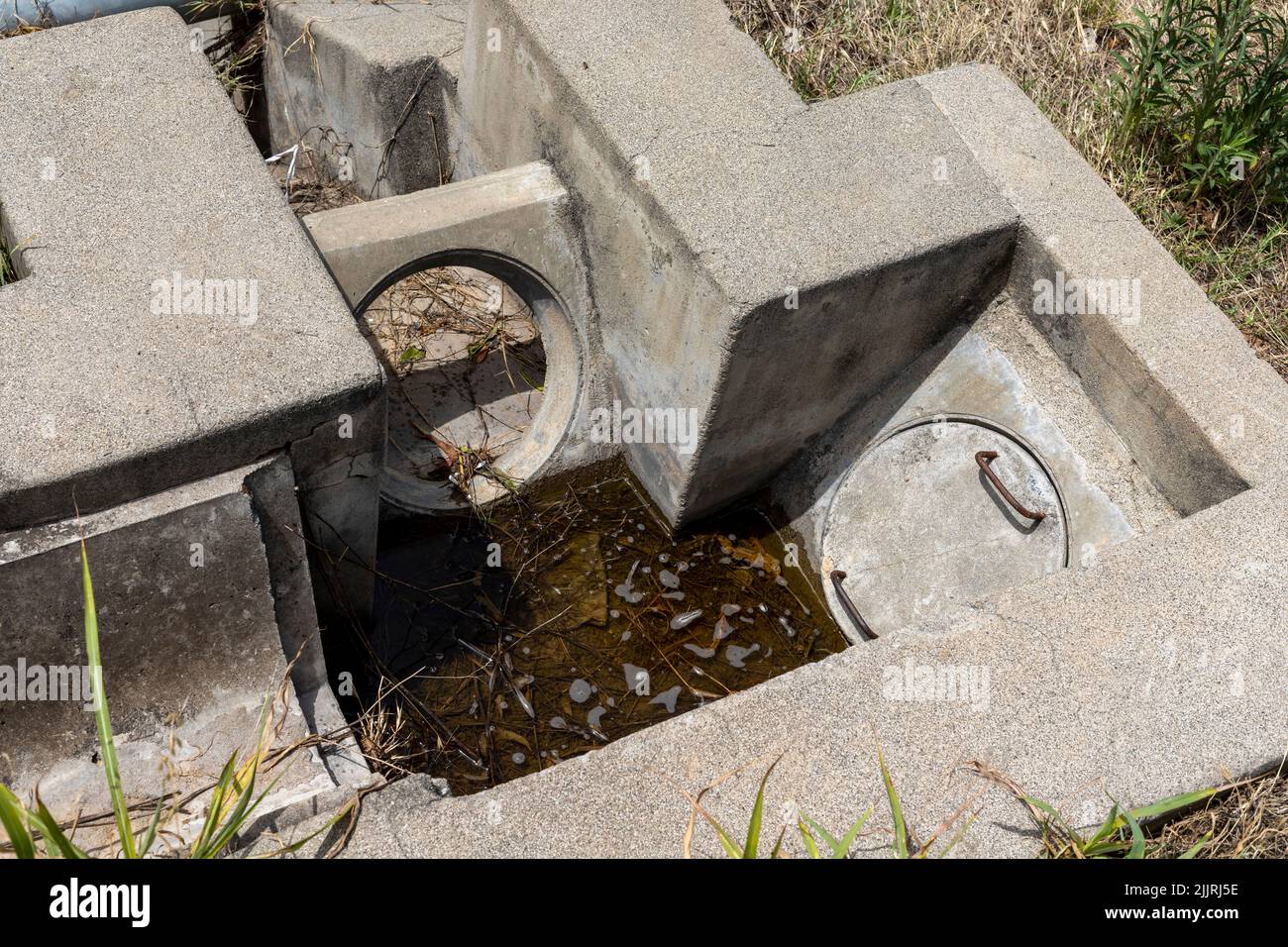 Drenaggio del calcestruzzo nei campi in giornata di sole. Foto Stock