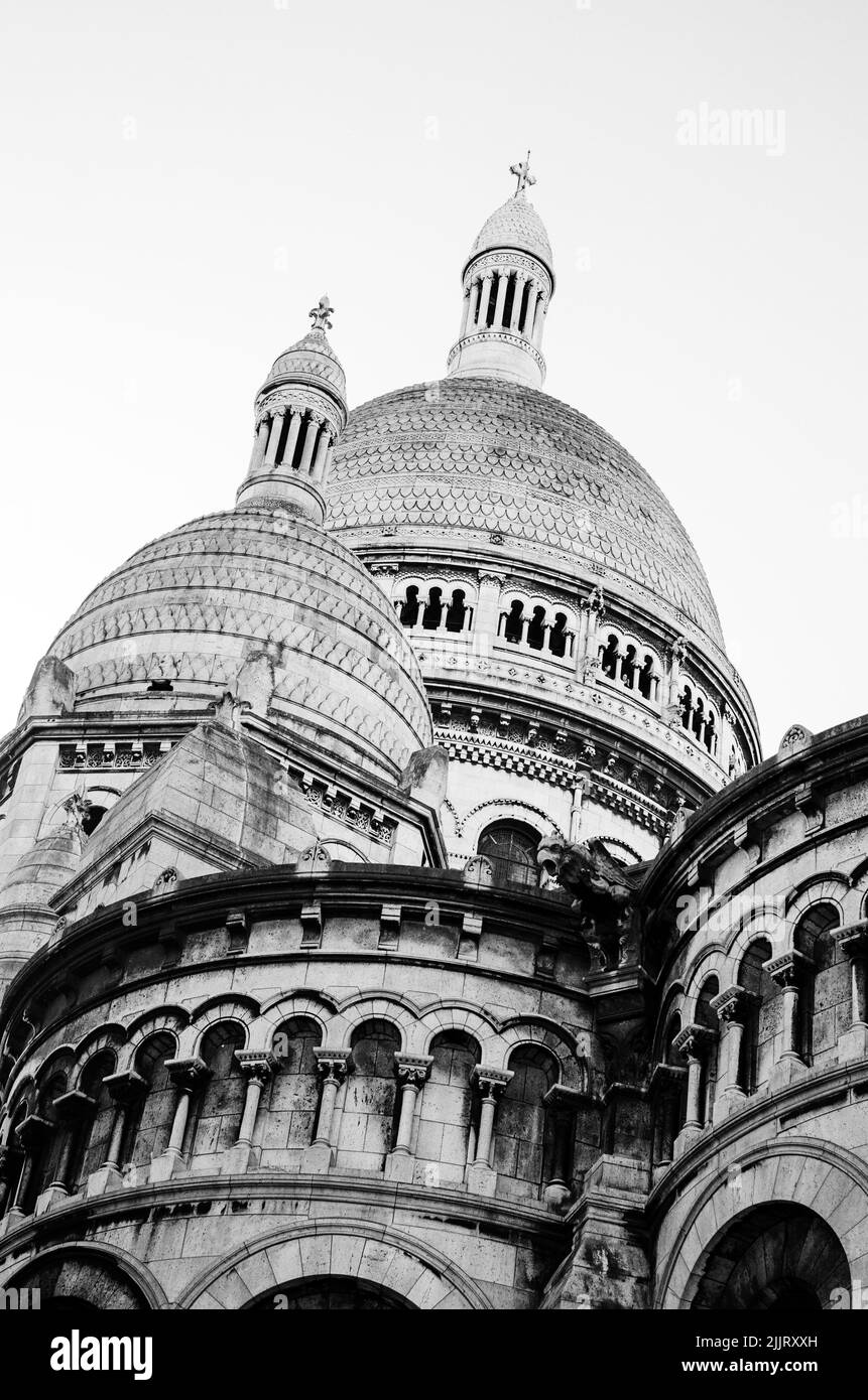 Un angolo basso della Basilica del Sacro cuore (Sacre-Coeur) a Parigi, Francia girato in scala di grigi Foto Stock