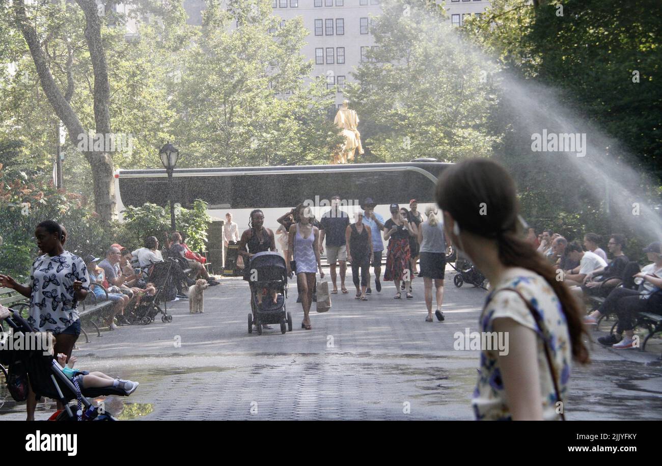 New York, Stati Uniti. 28th luglio 2022. (NUOVO) le persone approfittano di un tubo rotto a Central Park bagnandosi con l'acqua. 28 luglio 2022, New York, USA: A causa del caldo e del caldo che raggiunge 87Ã‚Â°F (30Ã‚Â°C), si vedono le persone approfittando di un tubo rotto a Central Park vicino all'ingresso di zooÃ¢â‚¬â„¢, giocando e bagnandosi con l'acqua da esso. La perdita tuttavia sta causando i problemi e le difficoltà affinchè alcuni passino vicino con i troll del bambino. (Credit Image: © Niyi Fote/TheNEWS2 via ZUMA Press Wire) Foto Stock