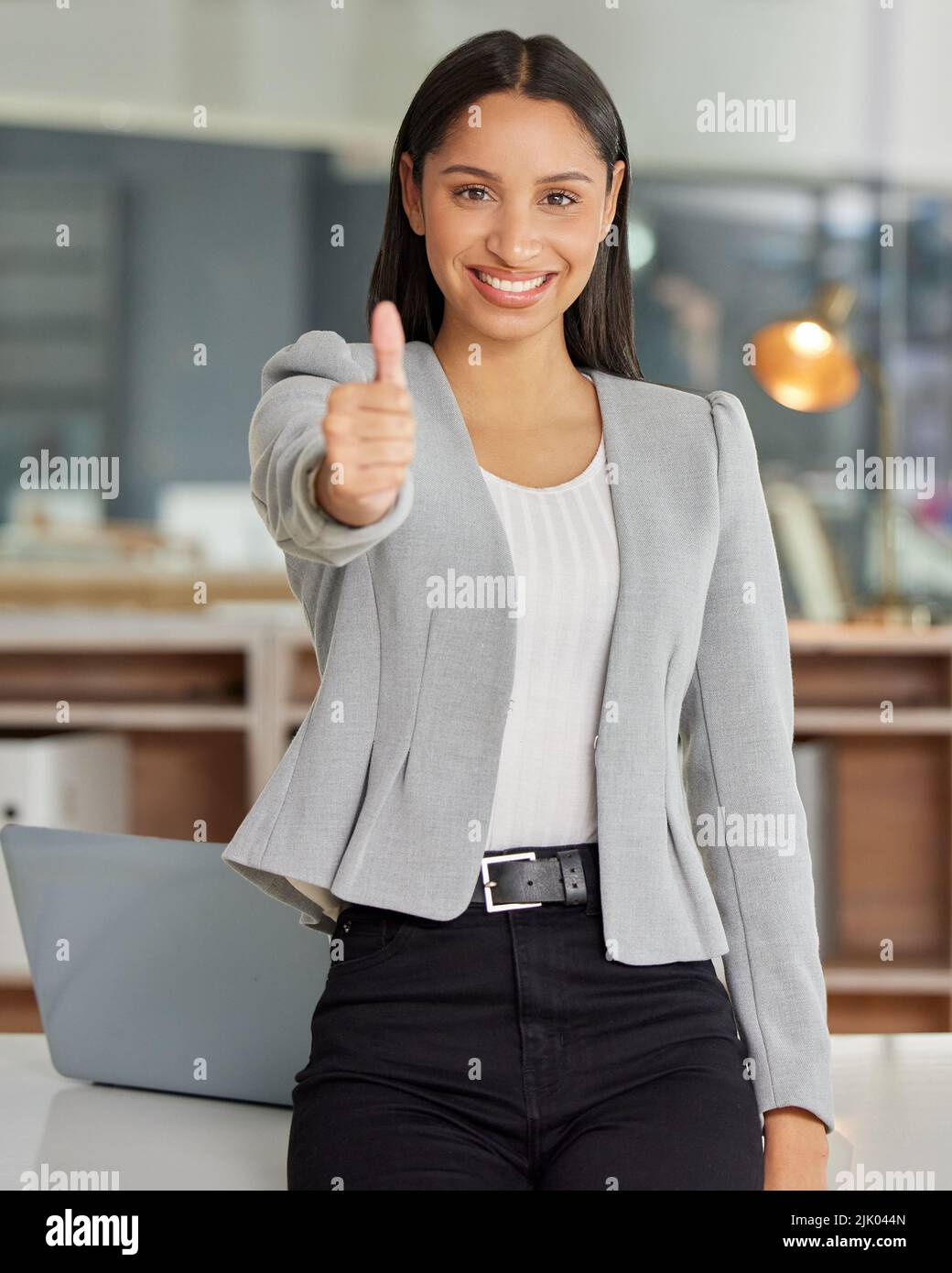 Credo in voi e anche voi dovreste. Ritratto di una giovane donna d'affari che mostra i pollici in un ufficio moderno. Foto Stock